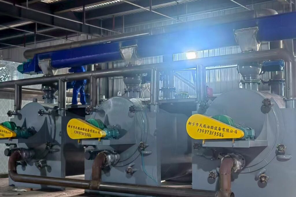 Three horizontal cookers being assembled in the workshop