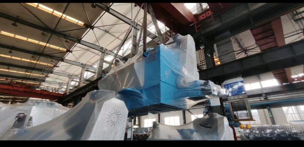 Overhead crane lifting a fabricated vessel in the workshop