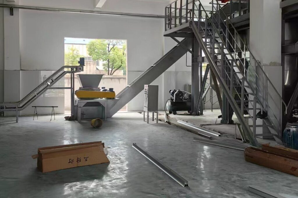 Newly built workshop with screw conveyor, hopper and steel access platform installed