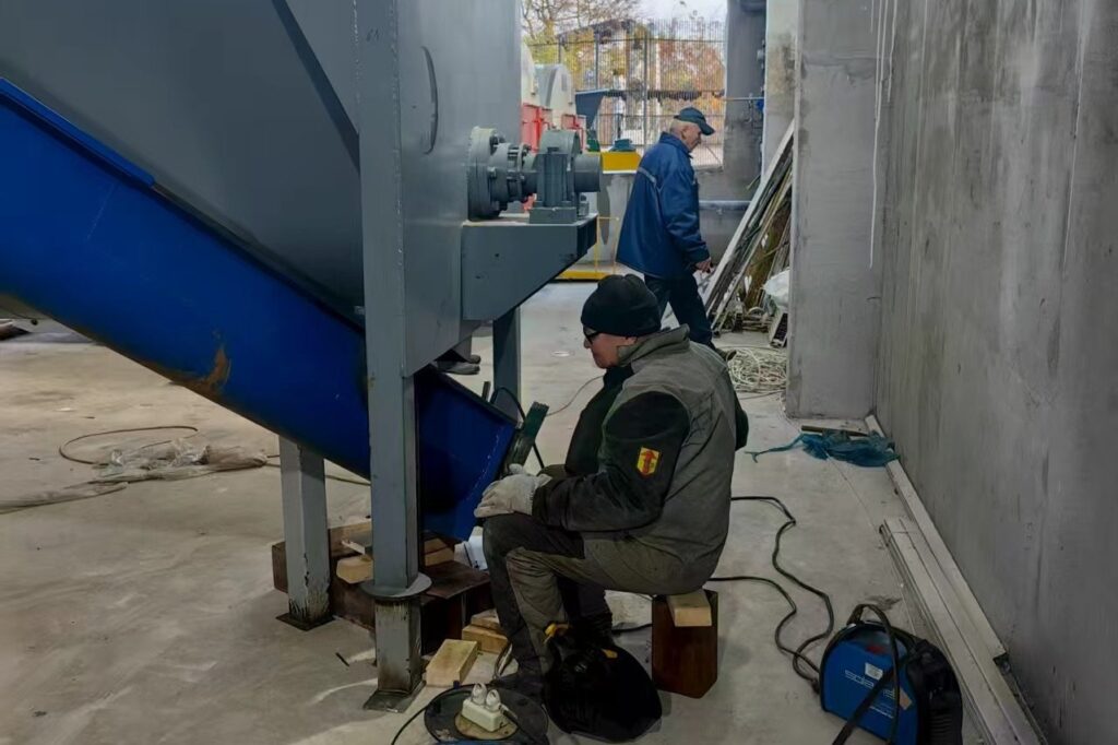 Welder grinding a fabricated steel frame in the workshop